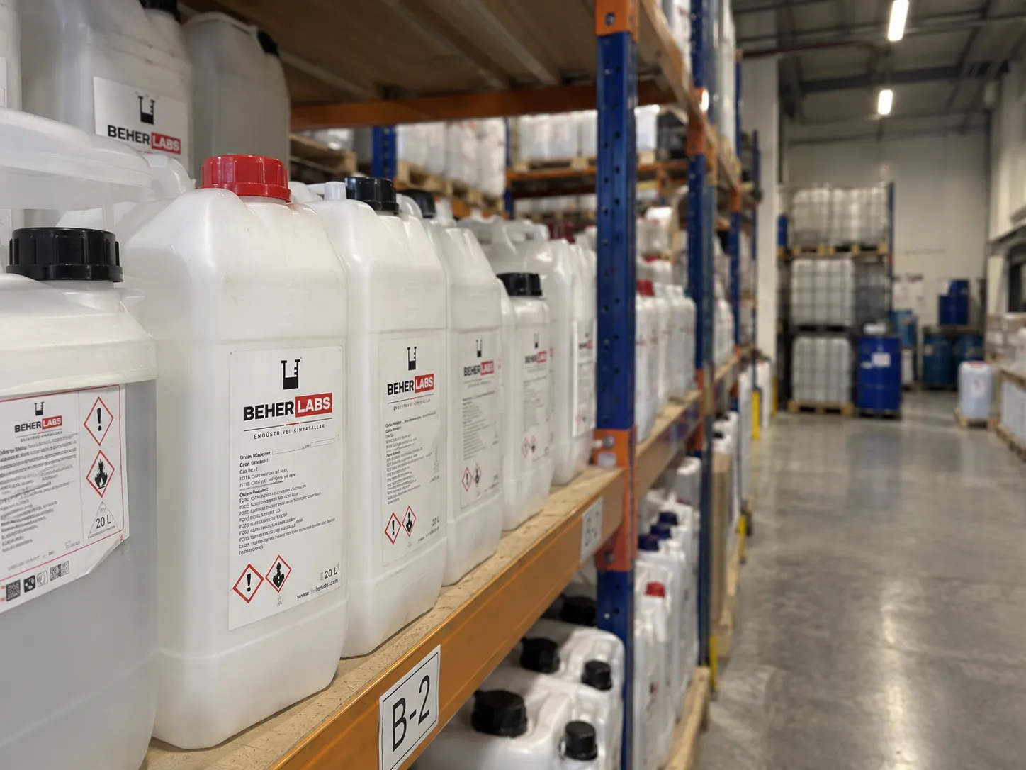 Labelled 20 L jerrycans on a warehouse shelf